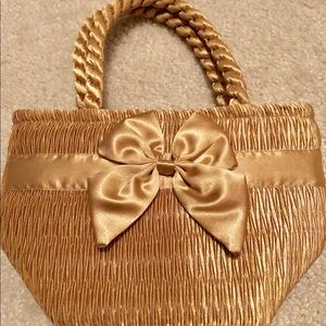 Cute petite tote in gold with a bow